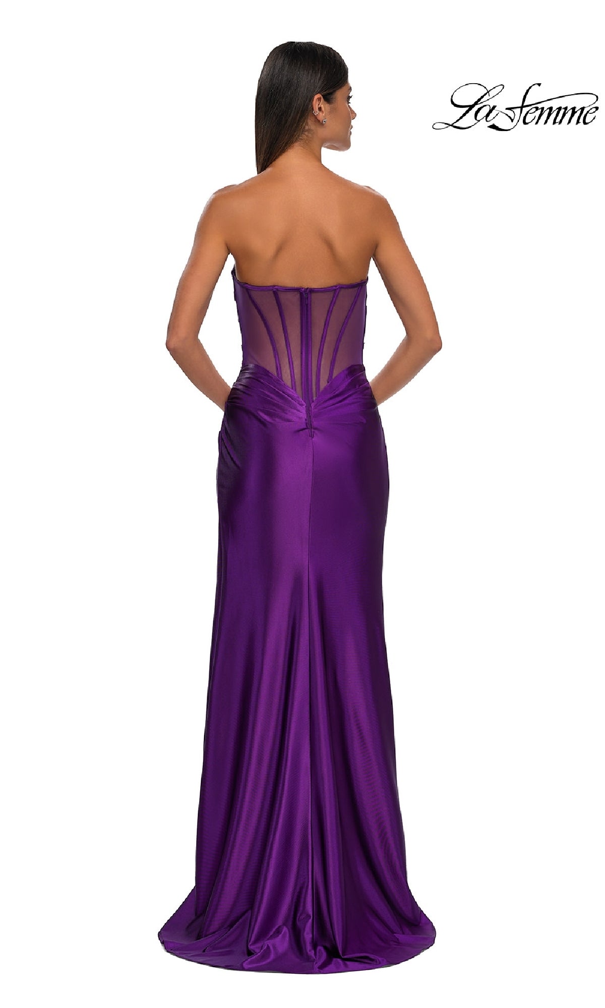 A woman models the Sheer-Back Strapless Prom Gown: La Femme 32649, featuring a purple satin sweetheart neckline and sheer corset-style back, against a plain white background.